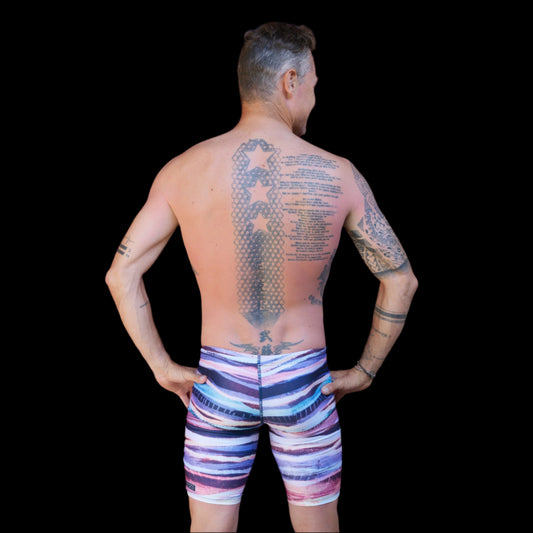 Fit Man wearing colourful earthy stripes pattern Jammers standing with hands on hips