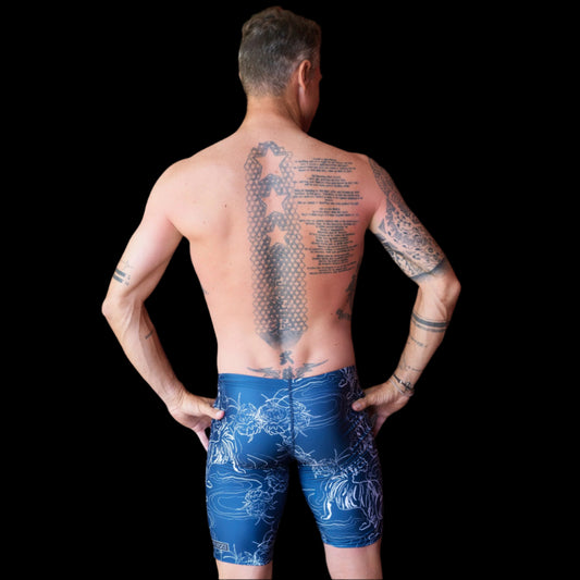 Fit Man wearing blue tiger and flower pattern Jammers standing with hands on hips