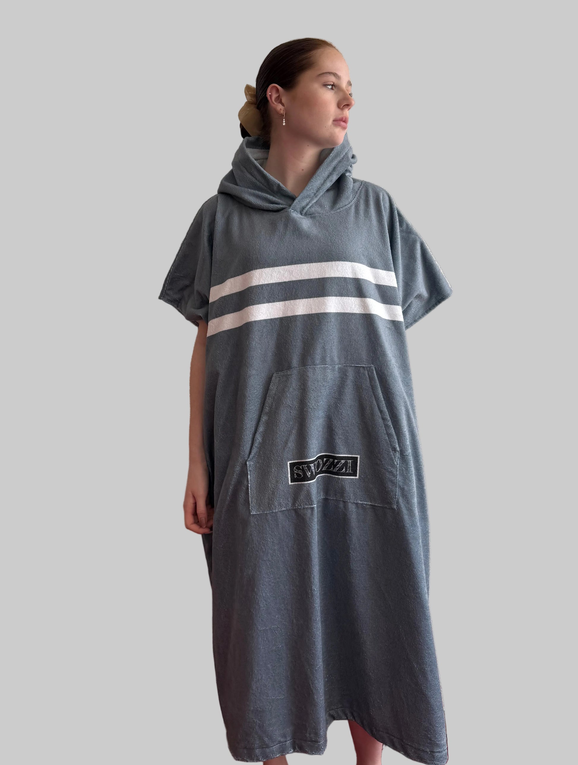 Person wearing a gray outfit with white stripes on a plain background