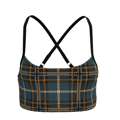 Plaid patterned crop top with black straps on a white background