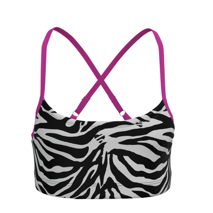 Zebra print sports bra with pink adjustable straps on a white background