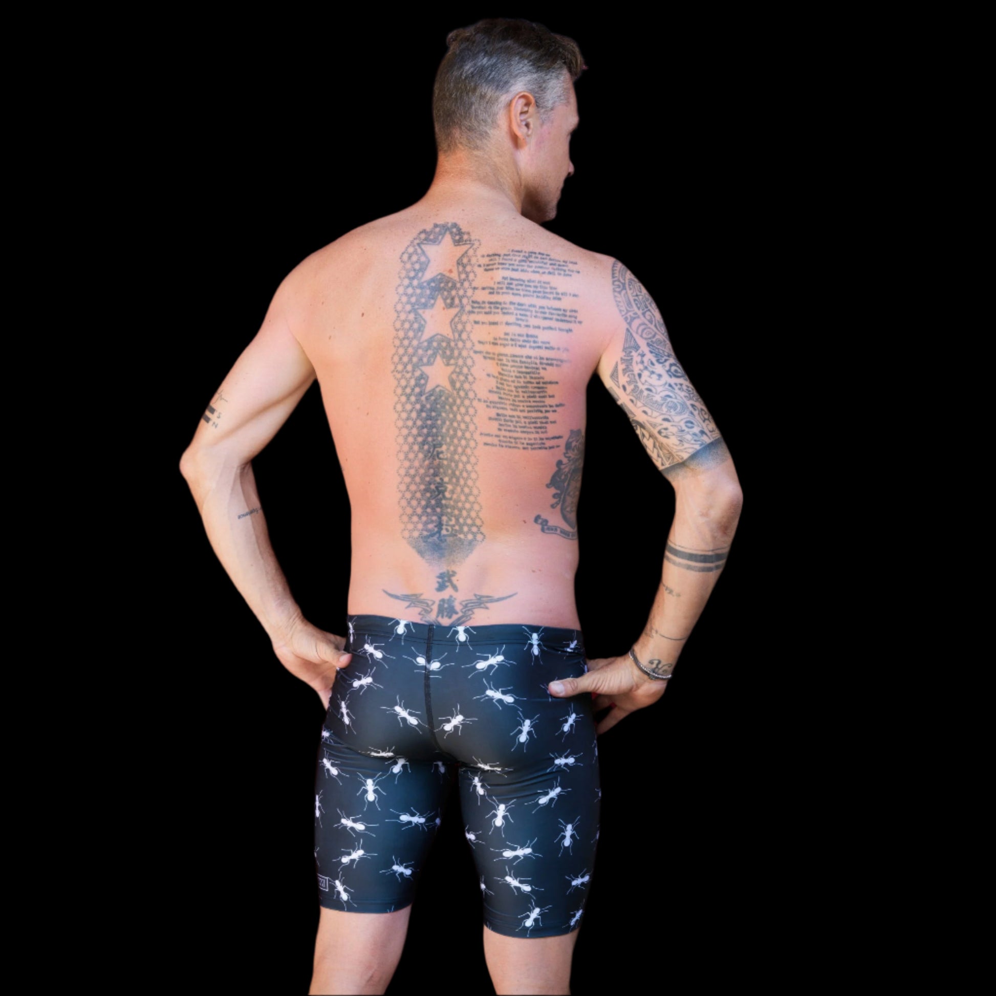 Fit Man wearing black Ants pattern Jammers standing with hands on hips