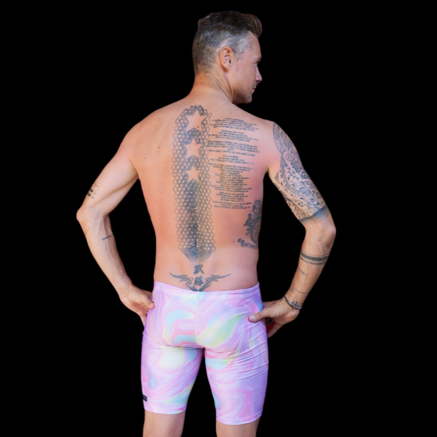 Fit Man wearing pink swirl  pattern Jammers standing with hands on hips
