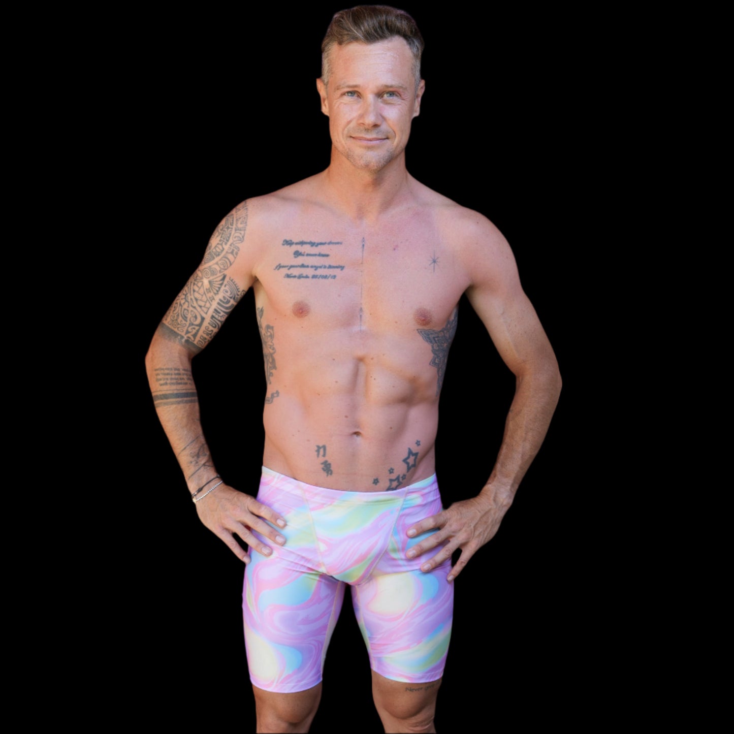Fit Man wearing pink swirl  pattern Jammers standing with hands on hips
