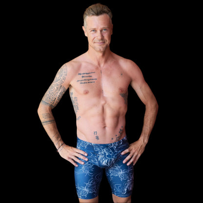 Fit Man wearing blue tiger and flower pattern Jammers standing with hands on hips
