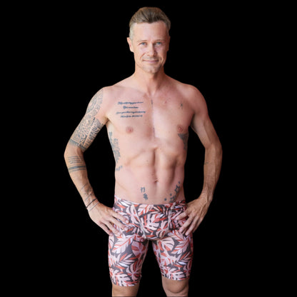 Fit Man wearing wild foilage leaf pattern Jammers standing with hands on hips