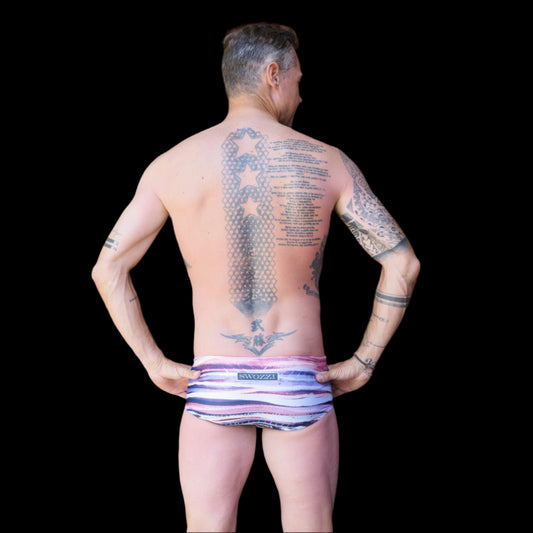 Fit man wearing Colourful stripes pattern one piece swimwear with a brand logo  hands on hips
